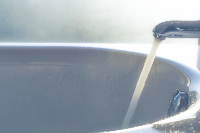 浴槽の蛇口から水を流しっぱなしにしている様子